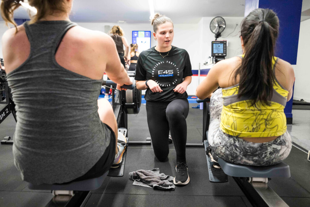 Personal training session at F45 Thousand Oaks with a coach guiding members through strength and cardio exercises.