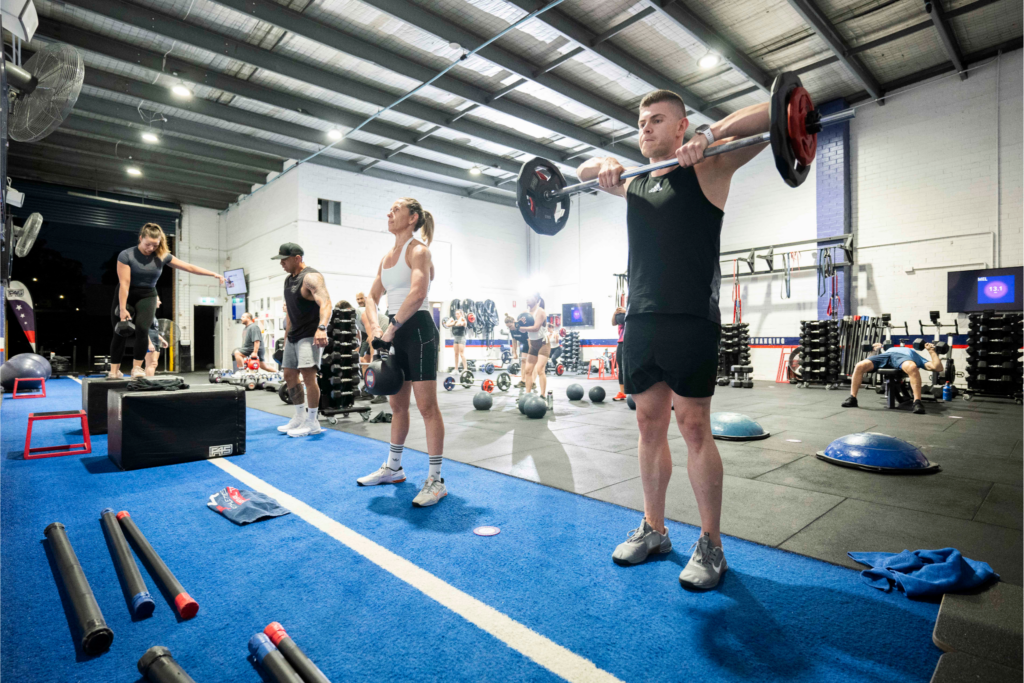 Group workout at an F45 Fitness class demonstrating functional training exercises