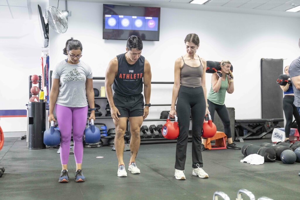 Group of professionals enjoying a high-energy HIIT class near me with supportive trainers and a motivating community.